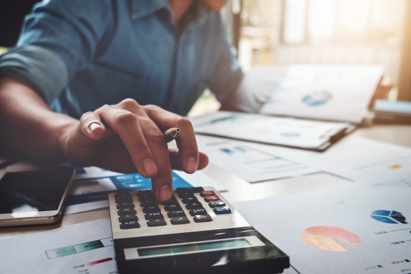 business person operating calculator